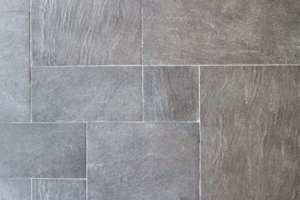 Close-up of grey stone tile flooring with a textured surface